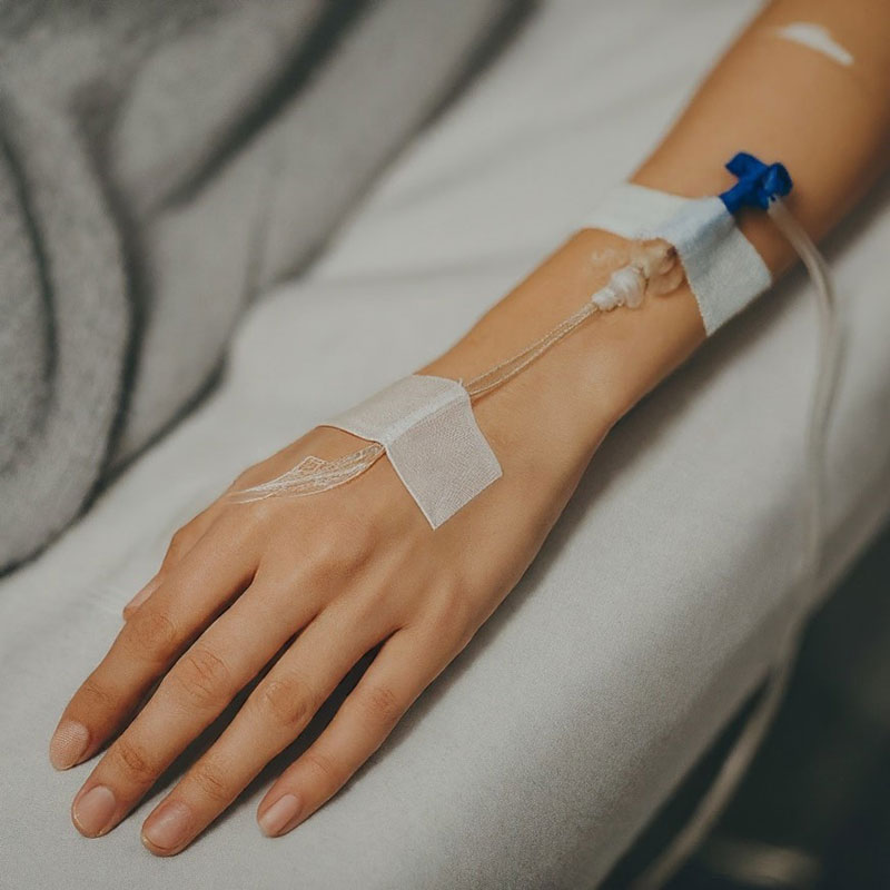 a person injecting glucose bottle