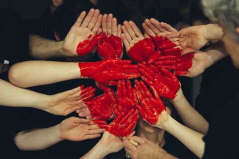 group of hands together with an image of a heart in the middle