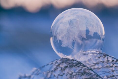 photo of a ball of ice in the wintertime with a snowflake pattern