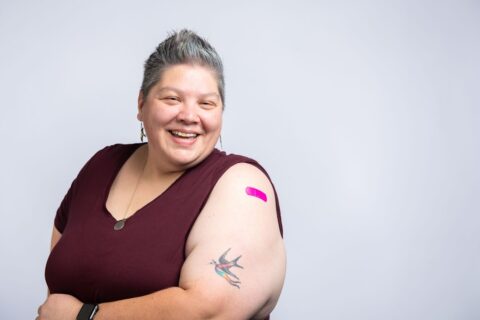 woman showing her arm for a vaccine