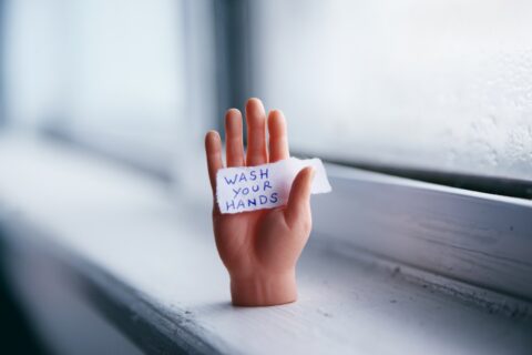 picture of a hand with a message saying wash me